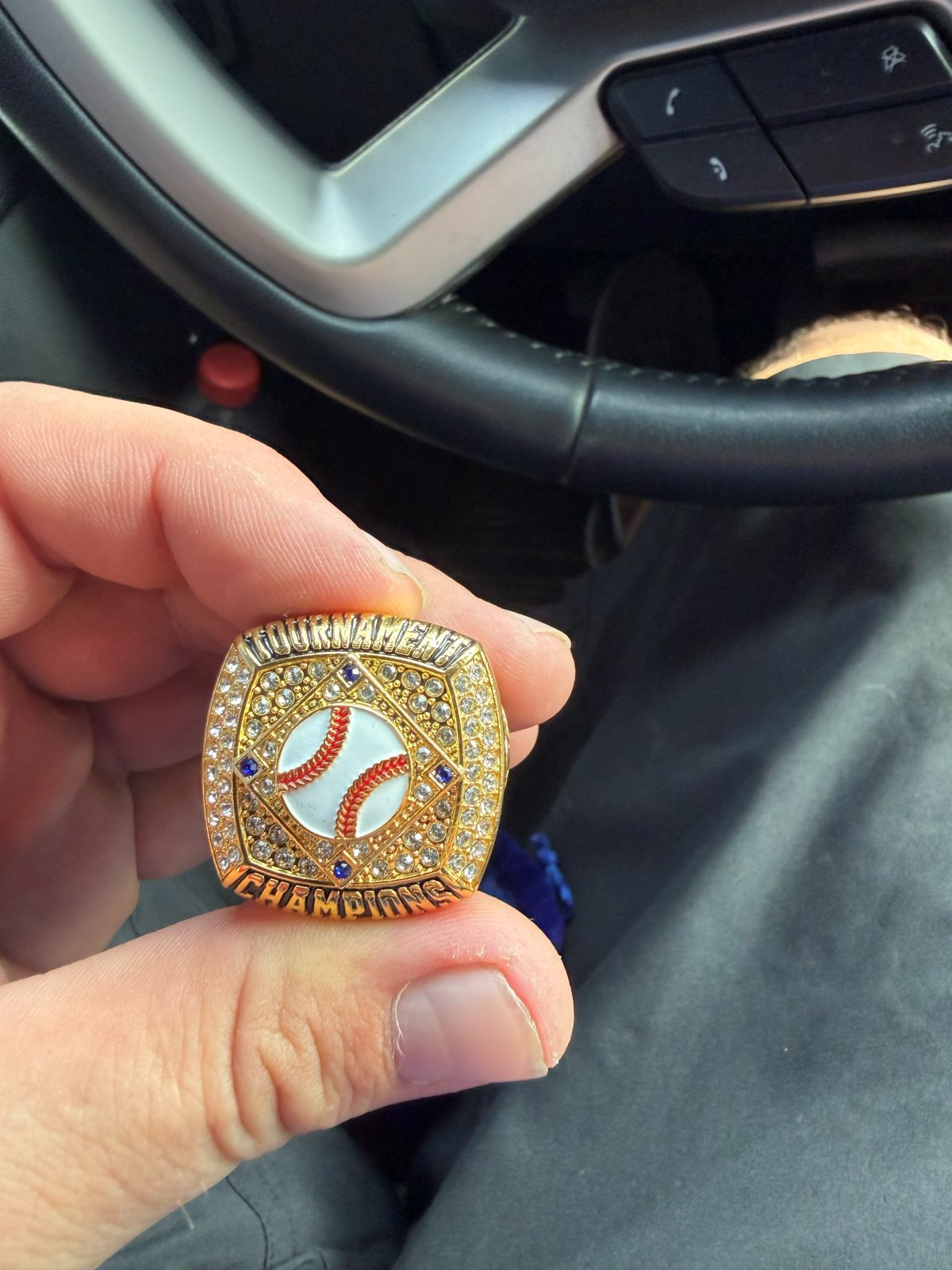 Gold tournament champions ring with a baseball in a diamond