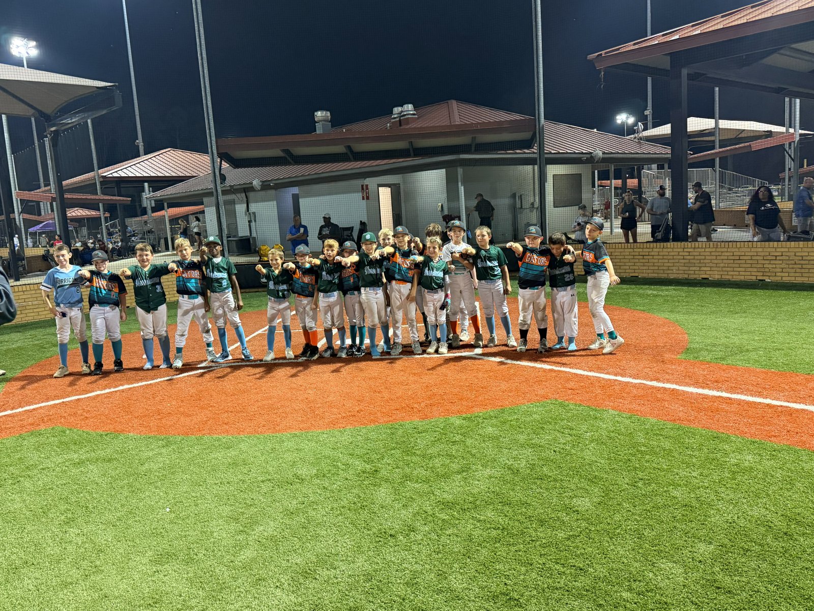 Team lined up on the field at night